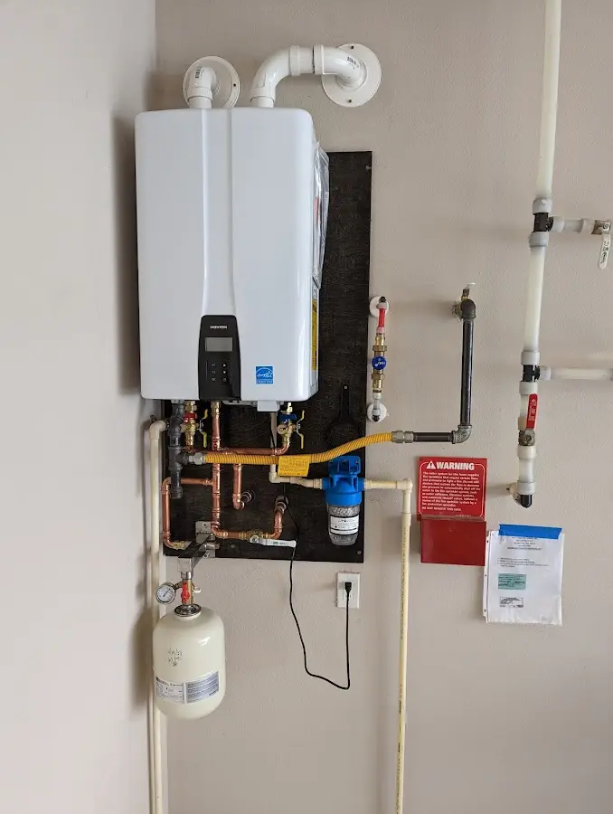 Professional plumber installing copper piping in a Milledgeville home